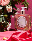 Santa Maria Novella Rosa Novella Liquid Soap showing with a rose bush sitting on bright pink cloth
