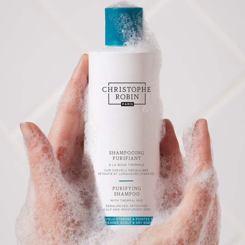 Christophe Robin Purifying Shampoo with Thermal Mud showing bottle with bubbles