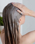 Christophe Robin Pre-Shampoo Hair Purifying Mud Mask showing model using on hair 