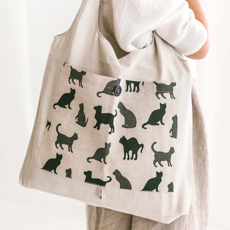 Sava Seasons Foldable Linen Shopper Tote – Natural Cats showing tote hanging from shoulder