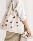 Sava Seasons Foldable Linen Shopper Tote – Ladybugs showing tote on shoulder and one tote folded in hand