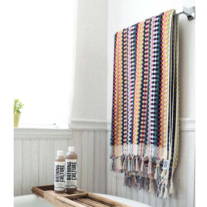 Bathing Culture Cosmic Rainbow Towel (Deadstock) showing towel hung on rack above a bath tub