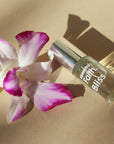 Essential Faith Bliss Roll-On showing with orchid flower