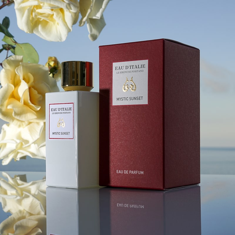 Eau d&#39;Italie Mystic Sunset Eau de Parfum Spray (100 ml) with box and white roses and ocean in the background