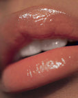 Close up of Roen Beauty Kiss My Liquid Lip Balm – Dodi on lips of model