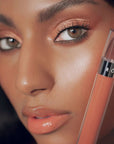 Close up of Roen Beauty Kiss My Liquid Lip Balm – Dodi on lips of model with dark skin tone
