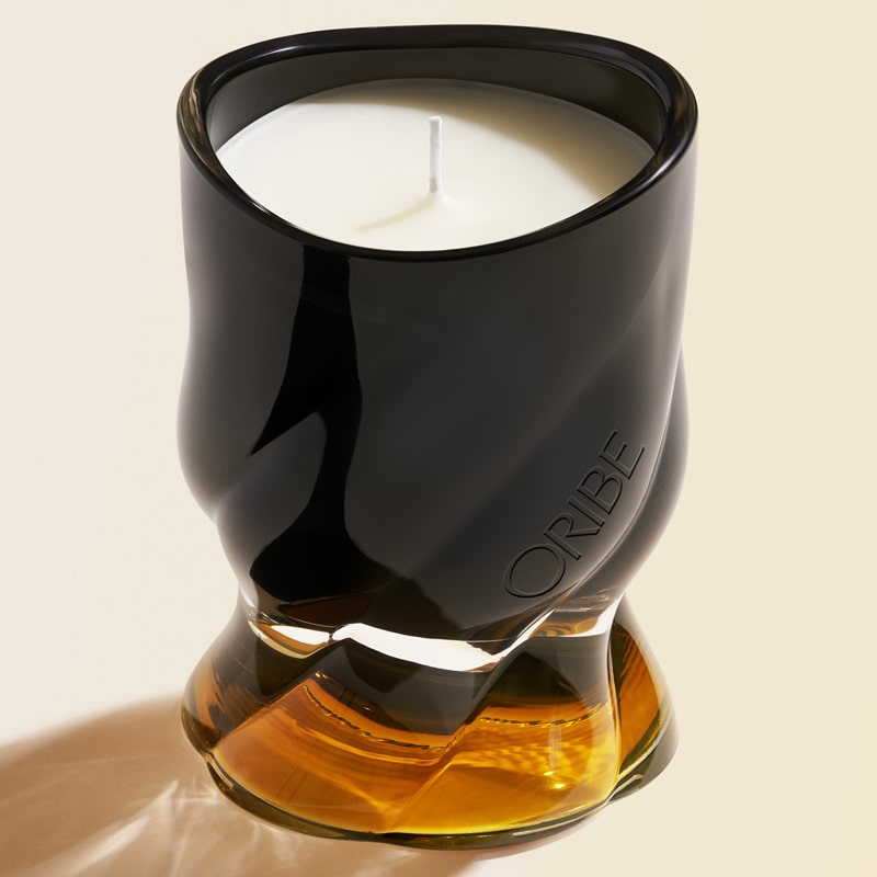 Oribe Cote d&#39;Azur Candle showing black and amber colored glass