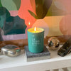 Kerzon Fragranced Candle – La Tour Eiffel showing candle lit sitting on a stone block