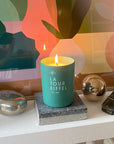 Kerzon Fragranced Candle – La Tour Eiffel showing candle lit sitting on a stone block