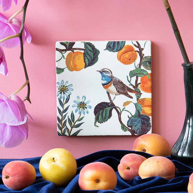 StoryTiles Small Tile – Sweet Late Summer shown on pink wall surrounded by fruit