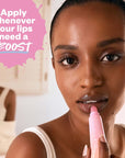 Kosas Cosmetics Plump & Juicy Lip Collagen Booster showing model putting on lips