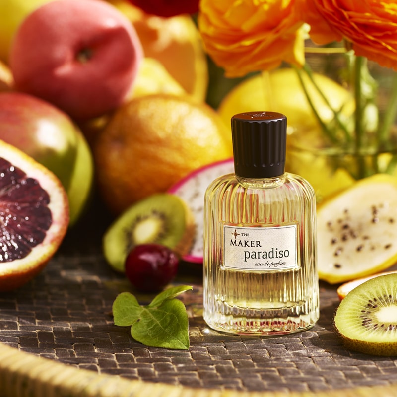 The Maker Paradiso Eau de Parfum (50 ml) showing on a tray surrounded by fruits