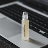 Susanne Kaufmann Eye Rescue Serum beauty shot of bottle on laptop keyboard