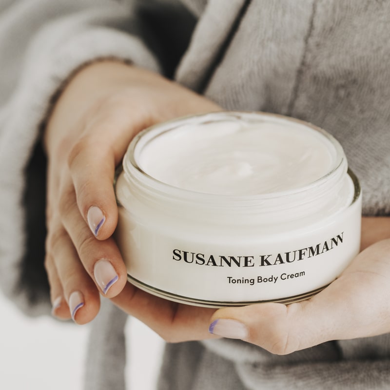 Susanne Kaufmann Body Butter showing jar in model's hands