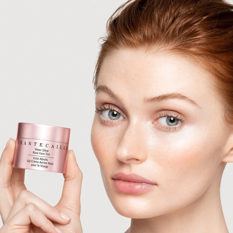 Chantecaille Sheer Glow Rose Face Tint showing model holding jar of product