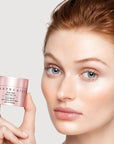 Chantecaille Sheer Glow Rose Face Tint showing model holding jar of product