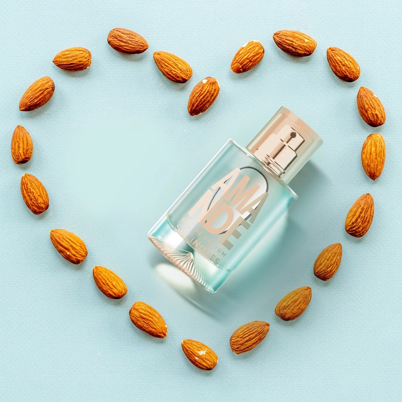 Solinotes Paris Amande (Almond) Eau de Parfum beauty shot of bottle surrounded by almonds arranged to form a heart outline (not included)