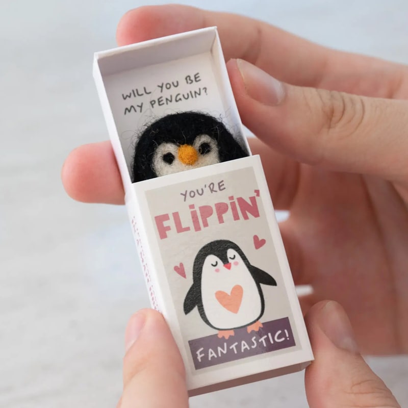 Marvling Bros Ltd You&#39;re Flippin&#39; Fantastic Wool Felt Penguin In A Matchbox showing open matchbox in model&#39;s hands for size perspective