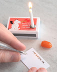 Marvling Bros Ltd Your Fire Can Light The World Mindfulness Gift showing model's hands writing a note with candle burning