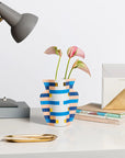 Octaevo Mini Paper Vase Costa shown on a desk with flower inside and lamp and books beside
