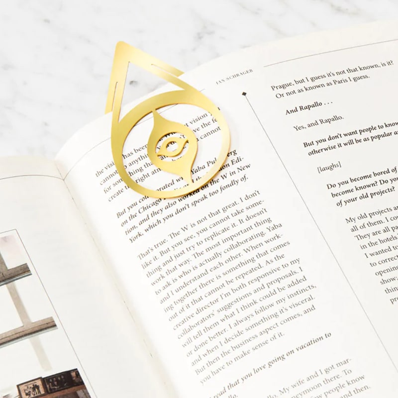 Octaevo Brass Nazar Bookmark shown attached to a book page