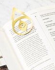Octaevo Brass Nazar Bookmark shown attached to a book page