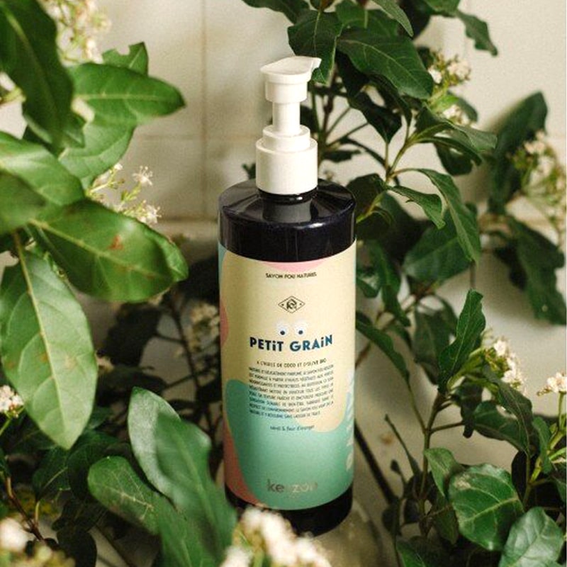 Kerzon Liquid Body Soap – Petit Grain - beauty shot  of bottle among greenery and flowers