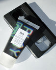 R+Co Cassette Curl Defining Masque + Superseed Oil Complex - Product shown on top of video cassette. 