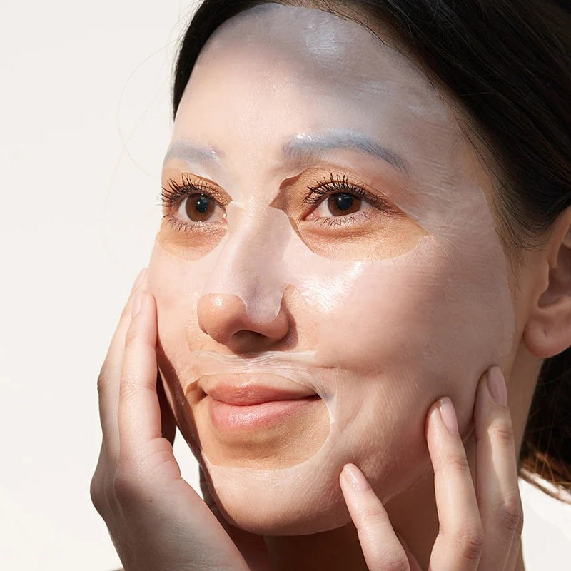 Cinq Mondes Express Recovery Biocellulose Mask - Product shown on model&#39;s face
