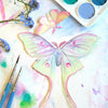 Moth & Myth North American Insect Watercolor Kit - Product displayed colored with paint brushes and water colors. 