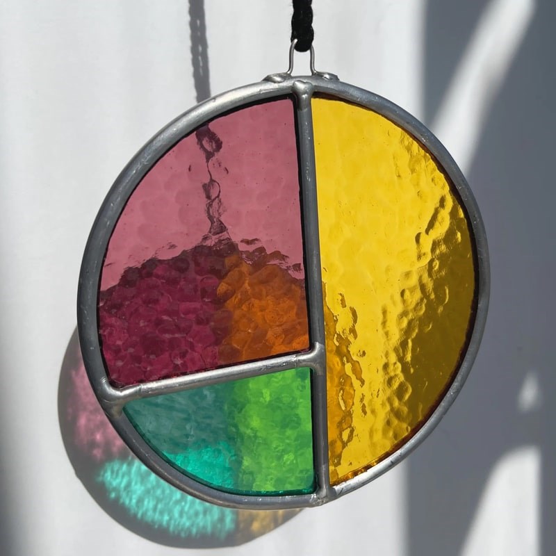 Chelbie Hunger Glassworks Fall Orchard Sun Charm - Product displayed with sun shining through