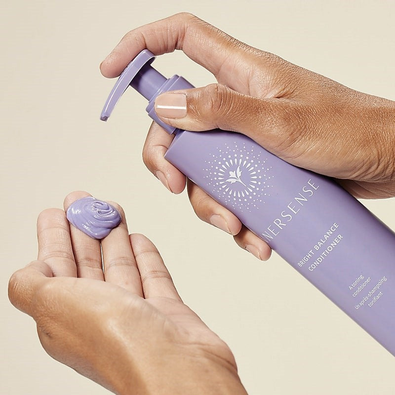 Innersense Organic Beauty Bright Balance Conditioner - Model shown dispensing product into hand
