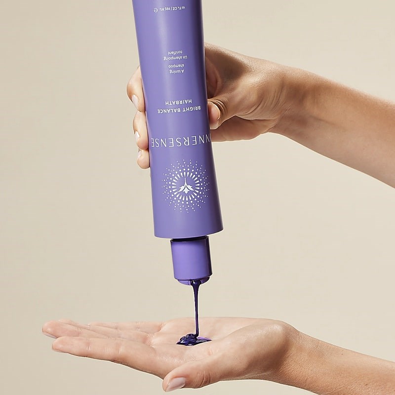 Innersense Organic Beauty Bright Balance Hairbath - Model shown dispensing product into hand