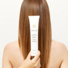 Innersense Organic Beauty Serenity Smoothing Cream - Product shown in front of models hair