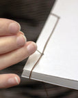 Oblation Papers & Press Leonardo Da Vinci Handmade Paper Inspiration Journal - Product shown next to models hand