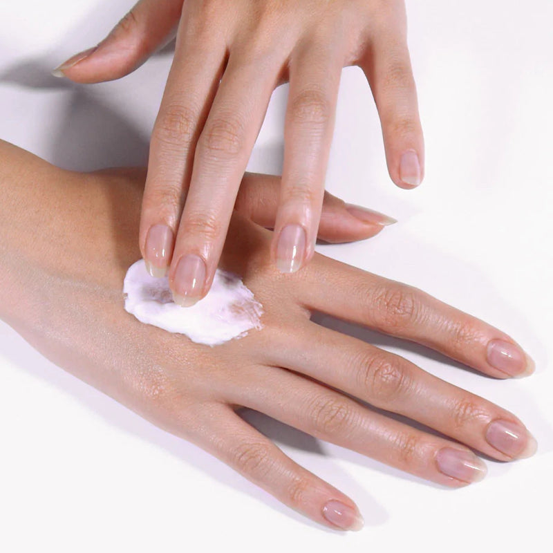 JINsoon Argan + Rose Moisturizing Hand Cream - Model shown rubbing product into hand