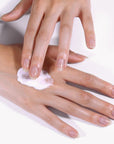 JINsoon Argan + Rose Moisturizing Hand Cream - Model shown rubbing product into hand