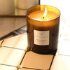 Essential Parfums Bois Imperial Scented Candle - Product shown lit on table