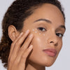 Chantecaille 24k Gold Energizing Eye Cream - Model shown applying product to face