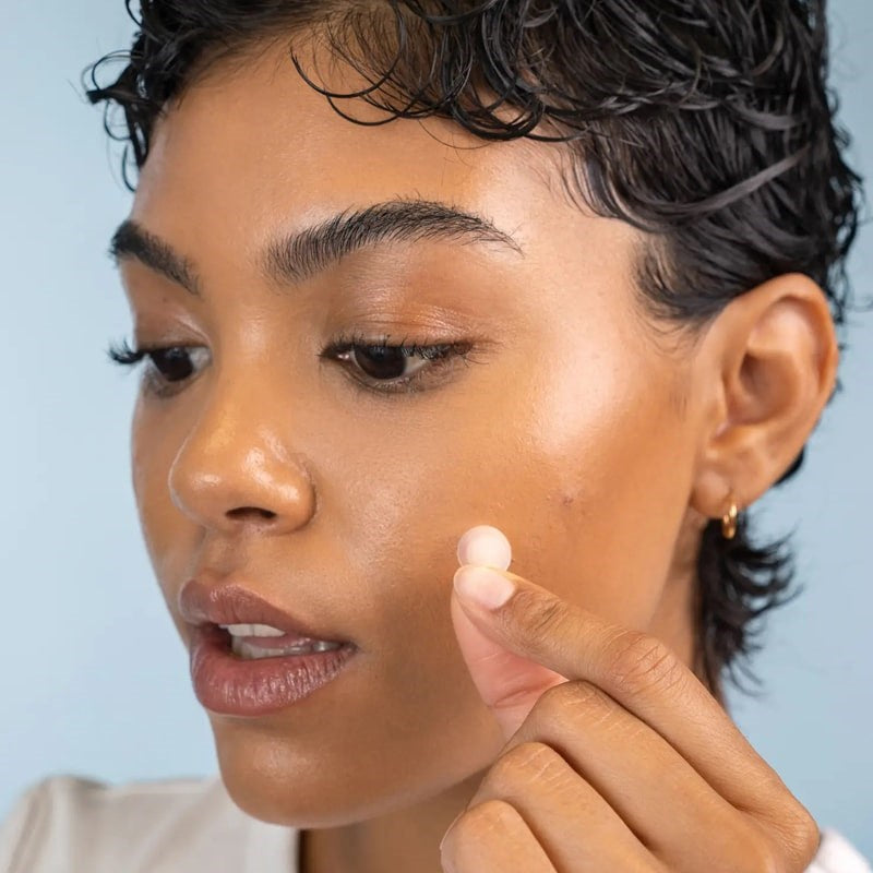 Clean Skin Club DermaDot Acne Patches - Model shown applying product