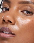 Kosas Plump & Juicy Vegan Collagen Spray-On Serum - Closeup of models face after applying product