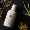 Neil Naturopathic Finishing Formula - Lightweight Conditioner - Product displayed next to plants