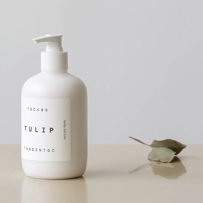Tangent GC Tulip Body Lotion - Product displayed next to leaf