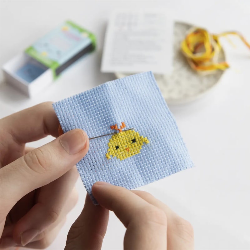 Marvling Bros Ltd Kawaii Chick Mini Cross Stitch Kit In A Matchbox - Finished product shown in models hand