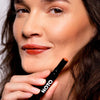 NOTO Botanics Multi-Bene Lips & Cheeks Stick – Fluxus - Model shown holding product next to face