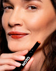 NOTO Botanics Multi-Bene Lips & Cheeks Stick – Fluxus - Model shown holding product next to face
