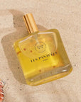 LES PANACEES Nourishing Dry Body and Hair Oil - Bouquet of Nature - Product displayed on beach sand