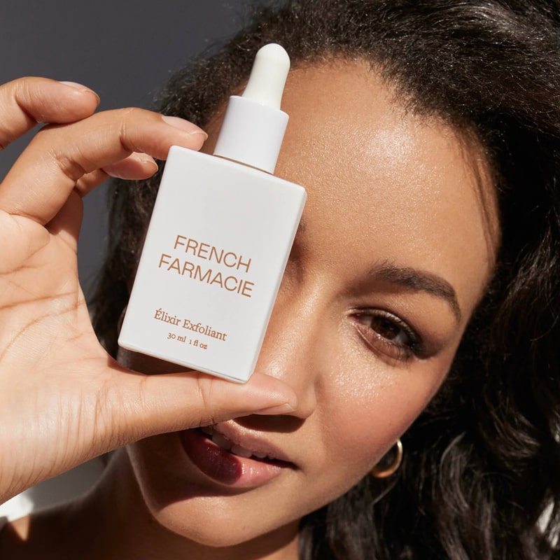 French Farmacie Elixir Exfoliant - Model displaying product in front of face