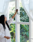 Koala Eco Natural Glass Cleaner - Model shown spraying product onto window