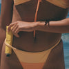 FORAH Everyday Mineral Sunscreen SPF 30 - Product displayed under models bath suit strap